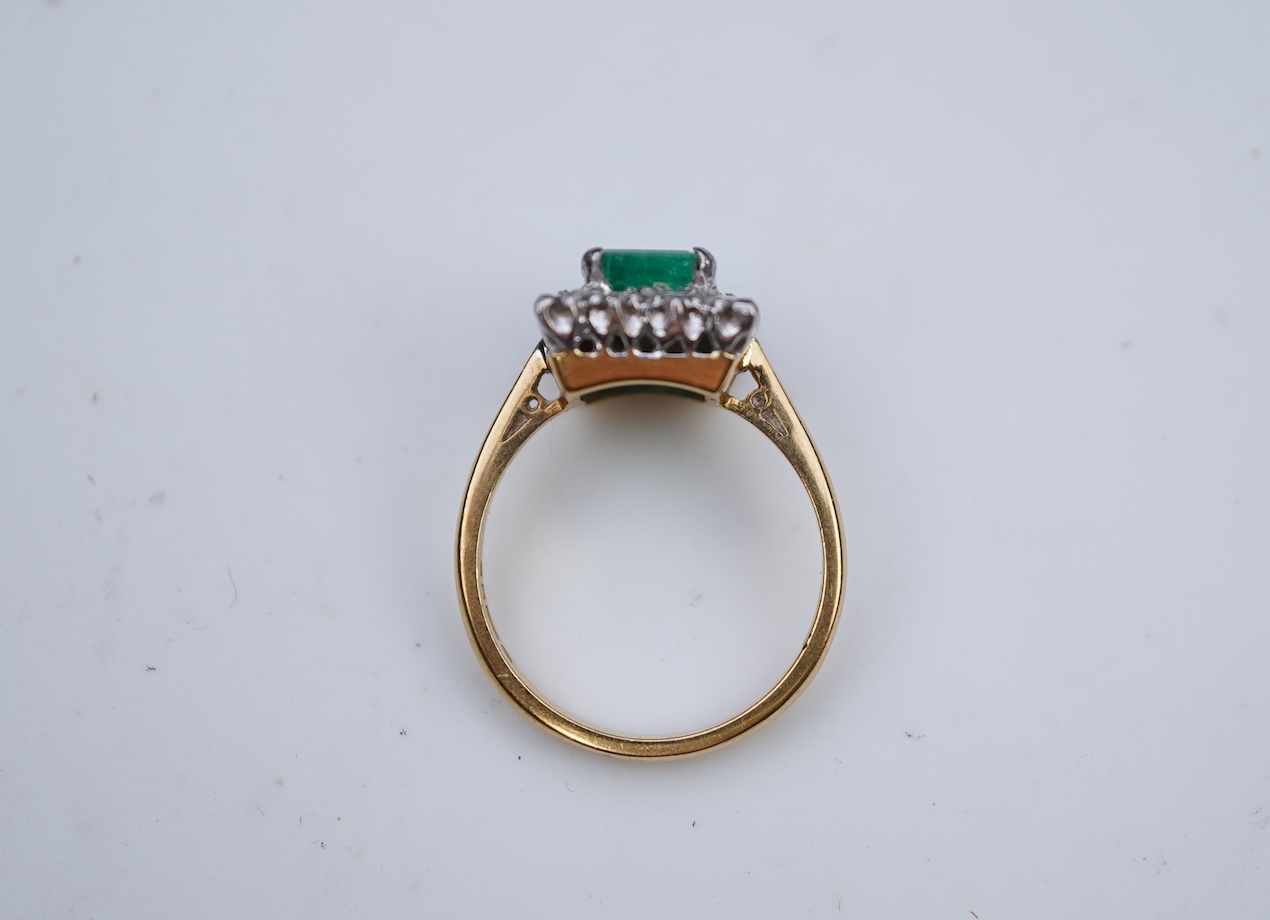 An emerald and diamond ring